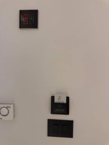an electronic device on a white wall with a scale at Kulla Emini Valbone 2025 in Valbonë