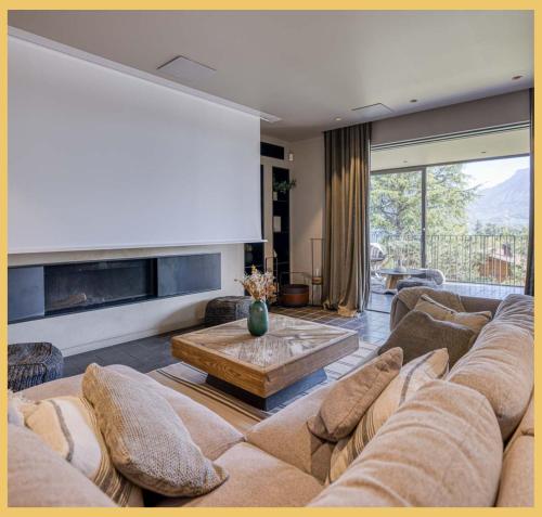 a living room with a couch and a table at Maison Gokan I Grand Annecy in Sévrier