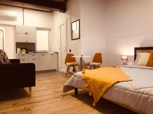 a bedroom with a bed with a yellow blanket on it at Budget Rooms by LA88 in St. Paul's Bay