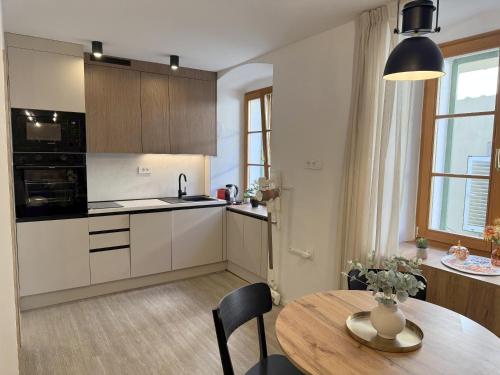 a kitchen with a table and a dining room at Four Seasons in Rijeka