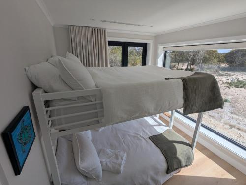 a bedroom with two bunk beds and a window at The Dunes in Island Beach