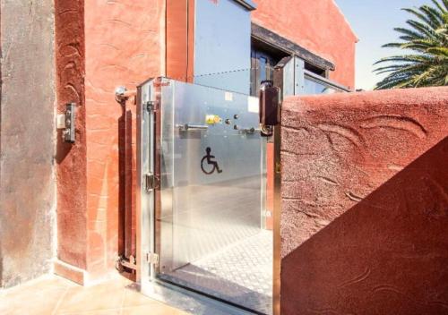 a glass door with a picture of a person riding a bike at Hotel Ecolife Tenerife in San Miguel de Abona