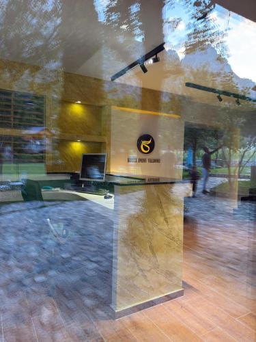 a reflection of a desk with a laptop in a window at Kulla Emini Valbone 2025 in Valbonë