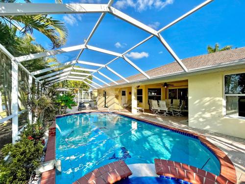a swimming pool in a house with a glass roof at Villa Malibu in Cape Coral Hospital Heliport