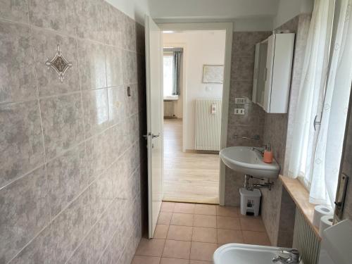 a bathroom with a sink and a toilet at SUITE DOLOMITI Appartamento in Falcade
