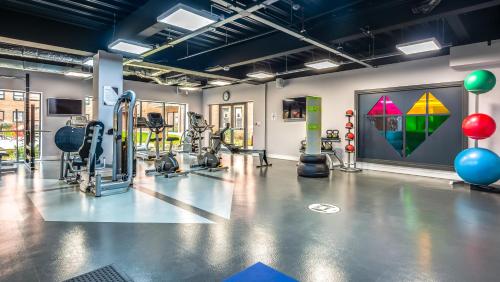 a gym with treadmills and exercise equipment in a room at The Glassworks in Headingley