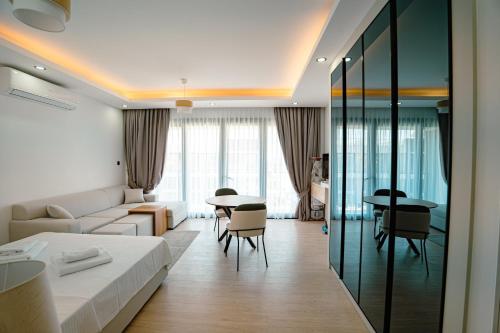 a hotel room with a bed and a table and chairs at Fabulous Studio at stunning Palmera Resort on Medditerranean coast in Karavas