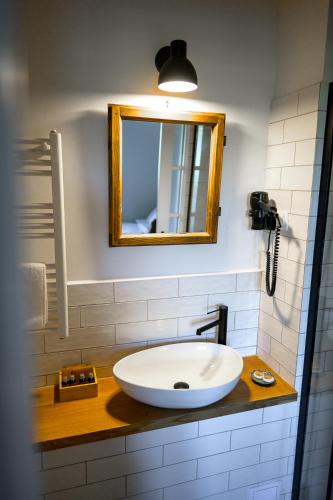 a bathroom with a white sink and a mirror at Ugron Castle Fiatfalva in Cristuru Secuiesc