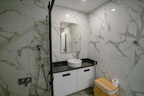 a bathroom with a sink and a shower with a mirror at Fabulous Studio at stunning Palmera Resort on Medditerranean coast in Karavas
