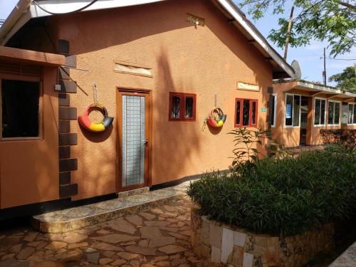 a house with two baskets on the side of it at Gorilla African Guest House in Entebbe