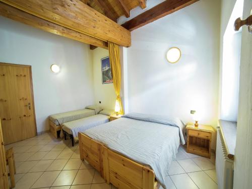 a bedroom with two twin beds and two windows at Apartment with Fireplace in Antey-Saint-André