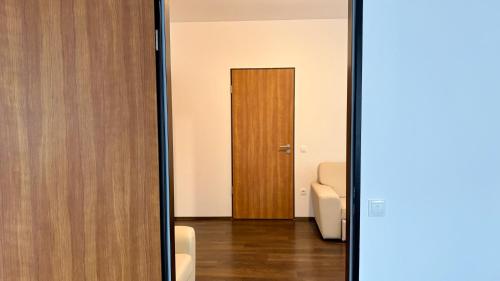 a mirror in front of a room with a door at Hotel Opal Superior - Adults Only in Gyöngyös