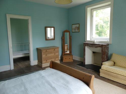 a bedroom with a bed and a fireplace and a mirror at Chateau Le Vieil Etang in Saint-Sauveur-le-Vicomte