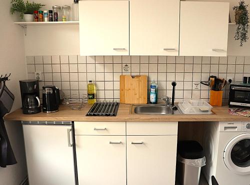 a kitchen counter with a sink and a microwave at Ferienwohnung Apartment am Klosterhof Aschersleben in Aschersleben