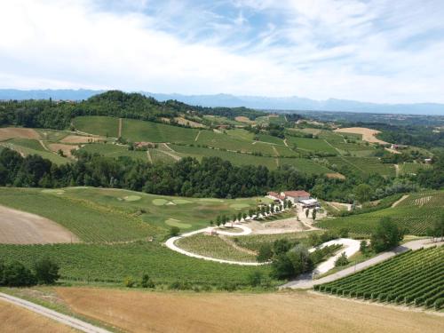 an aerial view of a golf course in a vineyard at Réva Resort in Monforte dʼAlba