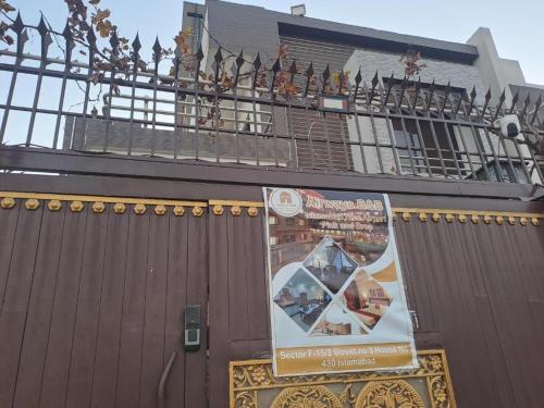 a brown fence with a sign on top of it at Airways B&B Islamabad Free Airport Pick and Drop in Islamabad