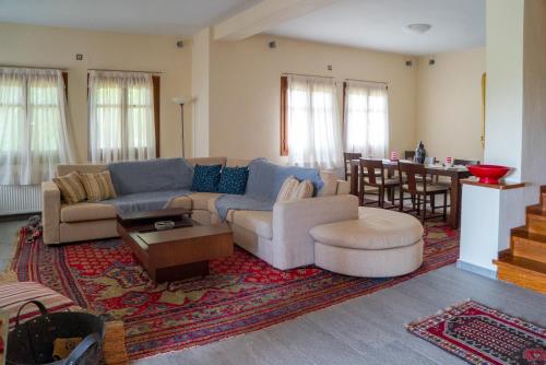 a living room with a couch and a table at Villa Maria Amalia in Tsagarada