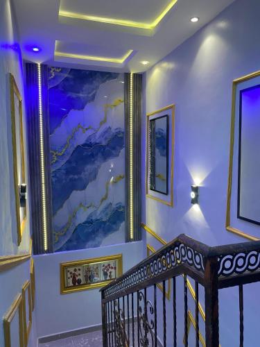 a staircase with a painting on the wall at Spectacular 3/4-Bed-Apt With 24hrs Power And FAST Wi-Fi in Amuwo