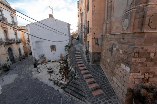 an alley with stairs leading up to a building at Casa Manbrù by Studio Vita in Siculiana