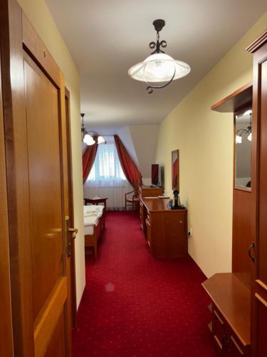 a corridor of a room with a red carpet at Penzion 77 - Garni in Pezinok