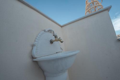 a bathroom with a sink and a toilet at Casa Manbrù by Studio Vita in Siculiana
