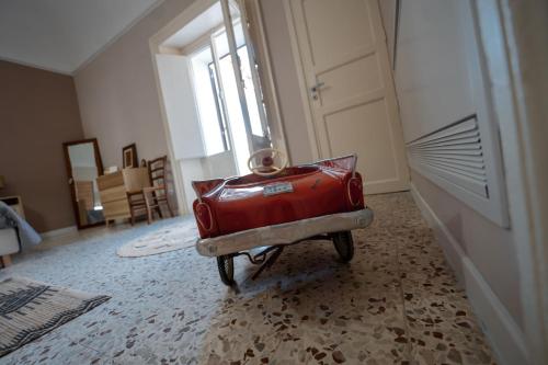 a red suitcase sitting in the middle of a room at Casa Manbrù by Studio Vita in Siculiana
