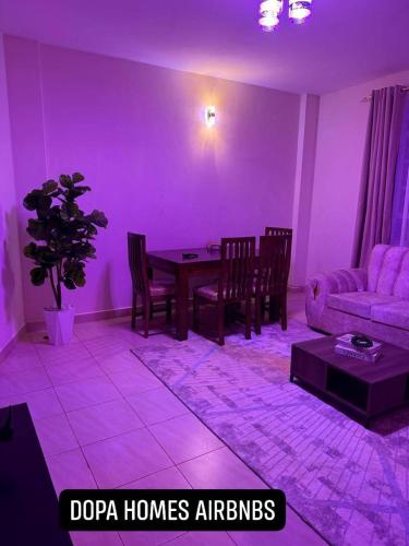 a purple living room with a table and a couch at Dopa Homes Airbnbs in Meru