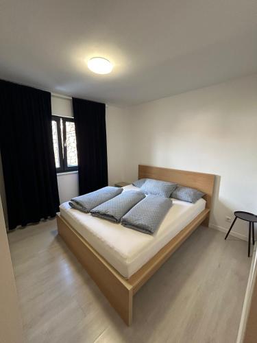 a bedroom with a large bed with blue pillows at Villa Laura in Gornji Vakuf