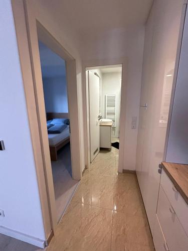 a hallway with a mirror and a bed in a room at Villa Laura in Gornji Vakuf