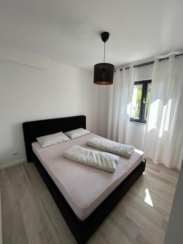 a bed with two pillows on it in a bedroom at Villa Laura in Gornji Vakuf