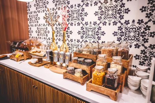 a buffet with jars of food on a table at Kameha Grand Bonn in Bonn