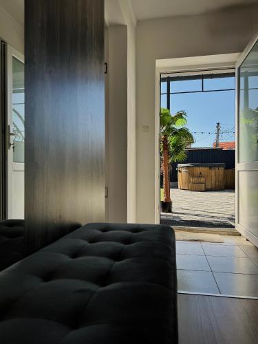 a living room with a couch and a sliding glass door at Relax House El Passo in Târgu-Mureş