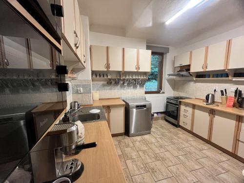 a large kitchen with wooden counters and stainless steel appliances at Horská Chalupa Nad Zubačkou in Desná