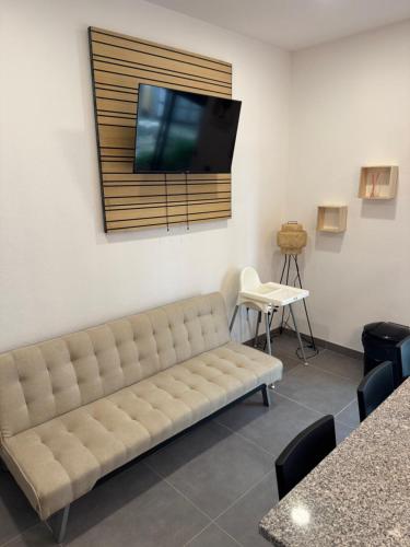 a living room with a couch and a flat screen tv at Beach Luxury Apartment in Praia de Mira