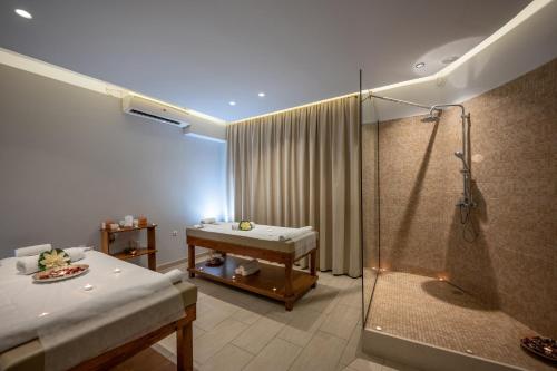 a bathroom with a shower and a sink at Royal & Imperial Belvedere Resort in Hersonissos