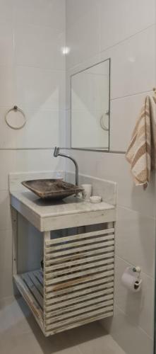 a bathroom with a sink and a mirror at Apartamentos da Casa Azul in Trancoso