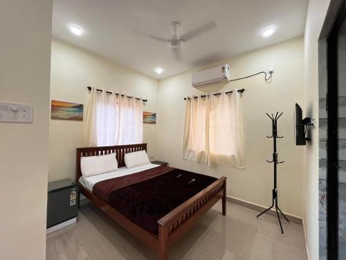 a bedroom with a bed and a air conditioner at The cozy Inn in Calangute