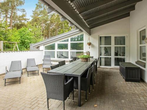 a patio with a table and chairs on a brick patio at 5 star holiday home in Sæby in Sæby