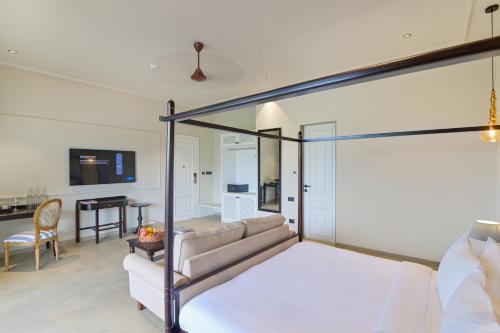 a bedroom with a bed and a living room at The Haven by Sula in Nashik