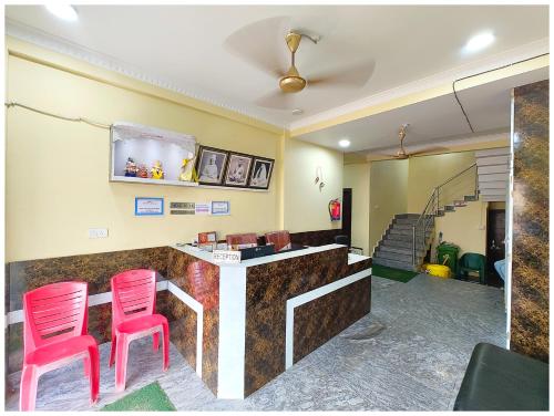 a bar with two pink stools in a room at SEA VIEW FAMILY HOTEL ANNAPURNA INN RESORT - Near Sea Beach - Jagarnath Temple - Golden Swargadwar Beach - Parking & Wi-Fi Facilities - Fully Air Conditioned Hotel in Prime location - Best Hotel In puri in Puri