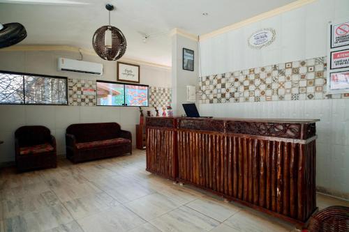 a room with a bar with a laptop on it at Pousada Familly Porto de Galinhas in Porto De Galinhas