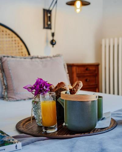 a tray with bread and a glass of orange juice at La Solenzara hôtel - 3 Etoiles Supérieur - Appartement & SPA in Sari Solenzara
