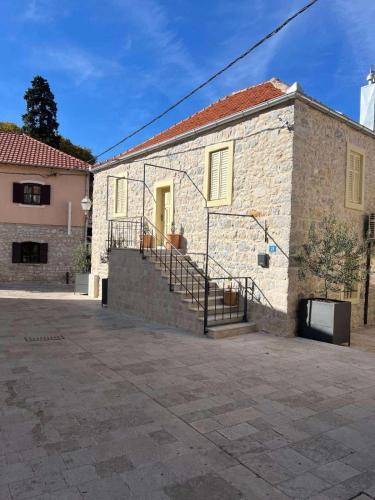 a brick building with stairs on the side of it at Tri Srca 1 - De Luxe 1 in Trebinje