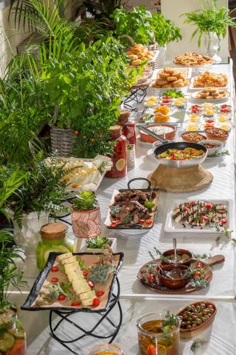 a buffet of food on a long table at Royal & Imperial Belvedere Resort in Hersonissos