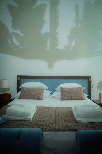 a large bed with two pillows on top of it at Once Upon Lisboa in Lisbon