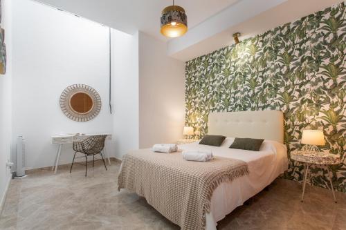 a bedroom with a bed and a wall mural at Casa Alicia in Corralejo