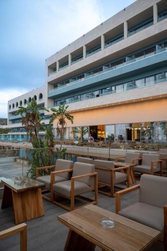 a hotel patio with tables and chairs and a building at Royal & Imperial Belvedere Resort in Hersonissos