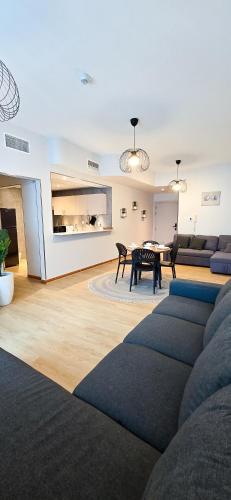 a living room with a couch and a table at Spacious Apartment Marina View in Dubai