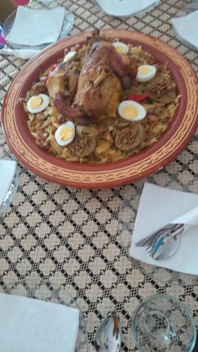 a plate of food with eggs on a table at Hotel Opéra Azrou in Azrou