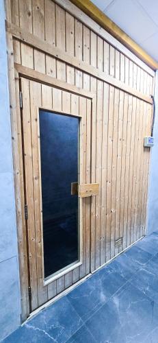 a wooden garage door with a window in it at Marina View Spacious 2 BHK in Dubai